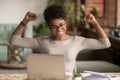 Excited african woman feeling winner rejoicing online win on laptop Royalty Free Stock Photo