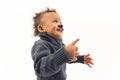 an excited Afro-American little boy with a fakr mustache, medium shot studio isolated Royalty Free Stock Photo