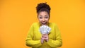 Excited Afro-American woman holding bunch of dollars, lottery winner, fortune Royalty Free Stock Photo