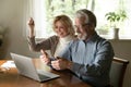 Excited aged wife celebrate victory of husband in computer game Royalty Free Stock Photo