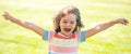 Excited amazed child on the green grass in summer park. Baby face closeup. Funny little kid boy close up portrait Royalty Free Stock Photo