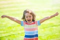 Excited amazed child on the green grass in summer park. Baby face closeup. Funny little kid boy close up portrait Royalty Free Stock Photo