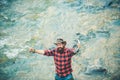 Excited amazed fisher man in water catching trout fish, top view. Fisherman man on river or lake with fishing rod. Royalty Free Stock Photo