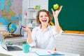 Excited amazed teacher. Modern attractive teacher. Portrait of smart young teacher with book in class at school. Study