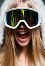 Excited amazed woman in ski goggles. Close up winter portrait of young amazing girl with snow goggles. Funny face. Royalty Free Stock Photo