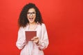 Excited amazed young beautiful woman with tablet pc. Happy girl in white shirt using tablet computer, isolated on red background Royalty Free Stock Photo