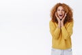 Excited, amused good-looking caucasian redhead woman with curly hair, look wondered and astonished, gasping fascinated
