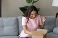 Excited Arabian woman received parcel, showing yes gesture, celebrating success