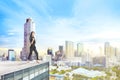 Excited asian business woman standing on the building rooftop Royalty Free Stock Photo