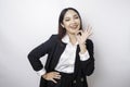 Excited Asian business woman wearing a black suit giving an OK hand gesture isolated by a white background Royalty Free Stock Photo