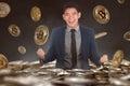 Excited asian businessman standing on bitcoin pile