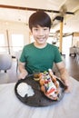 Excited asian child with smile face showing dessert Royalty Free Stock Photo