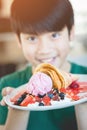 Excited asian child with smile face showing dessert Royalty Free Stock Photo