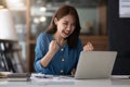 Excited asian female feeling euphoric celebrating online win success achievement result, young woman happy about good Royalty Free Stock Photo