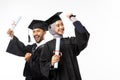 Excited asian female and male graduate students carrying certificate Royalty Free Stock Photo