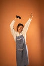 excited Asian girl with hands up and holding cell phone Royalty Free Stock Photo