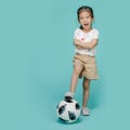 Excited Asian little girl playing football Royalty Free Stock Photo