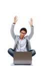 Excited Asian man using laptop on the floor Royalty Free Stock Photo