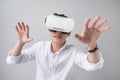 Excited asian man in a VR goggles and gesturing with his hands Royalty Free Stock Photo