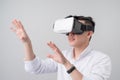 Excited asian man in a VR goggles and gesturing with his hands Royalty Free Stock Photo