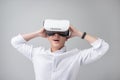 Excited asian man in a VR goggles and gesturing with his hands Royalty Free Stock Photo