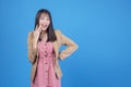 Excited Asian positive businesswoman wear suit holding hand on mouth cheerful successful job while standing with copy space over