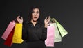 Excited asian woman holding colorful paper bag celebrating Black