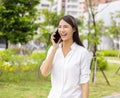 Excited asian young woman talking on the mobile phone Royalty Free Stock Photo