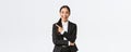 Excited attractive asian female saleswoman, real estate agent in suit suggesting perfect house, standing in suit and