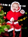 Excited baby sitting on present box