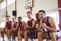 Excited basketball player sitting on bench Royalty Free Stock Photo