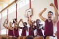 Excited basketball player sitting on bench Royalty Free Stock Photo