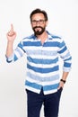 Excited bearded man with glasses holding forefinger up and looking enlightened with brilliant idea. Man points up to info