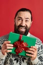 excited bearded man in winter sweater