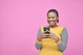 excited beautiful african lady smiling while using her mobile phone