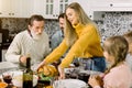 Excited beautiful family looking at thanksgiving turkey. Young woman holds the plate with roast chicken or turkey Royalty Free Stock Photo