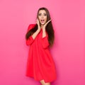 Excited Beautiful Woman In Red Mini Dress Is Holding Head In Hands