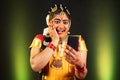 excited Bharatnatyam dancer by seeing as winner on mobile phone - concept of online shopping e-commerce offers, final