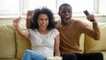 Excited biracial couple have fun watching sports game together Royalty Free Stock Photo