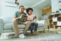 Excited Black Boy playing video games with his African American Father Royalty Free Stock Photo