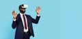 Excited Black Businessman Wearing VR Glasses And Suit Standing On Blue Background Royalty Free Stock Photo