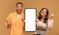 Excited Black Couple Demonstrating Big Smartphone With White Screen And Celebrating Success, Royalty Free Stock Photo