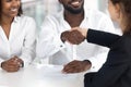 Excited black couple handshake female realtor closing deal