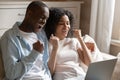 African spouses look at laptop scream with joy celebrate victory Royalty Free Stock Photo