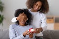 Excited black girl make birthday surprise for mom