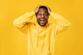 Excited Black Guy Shouting Touching Head Standing On Yellow Background Royalty Free Stock Photo