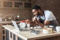 Excited black man baking and looking recipe on laptop Royalty Free Stock Photo