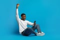Excited Black Man Celebrating Win, Using Cellphone Royalty Free Stock Photo