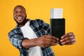 Excited Black Man Showing Travel Tickets Posing Over Yellow Background Royalty Free Stock Photo