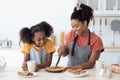 Excited black mom and daughter tasting homemade pie Royalty Free Stock Photo